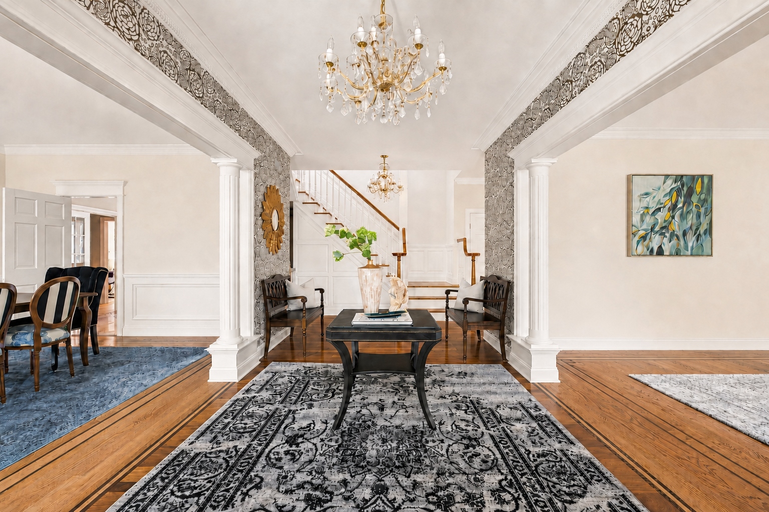 foyer at 285 Hartshorn Drive with a crystal chandelier and curved staircase