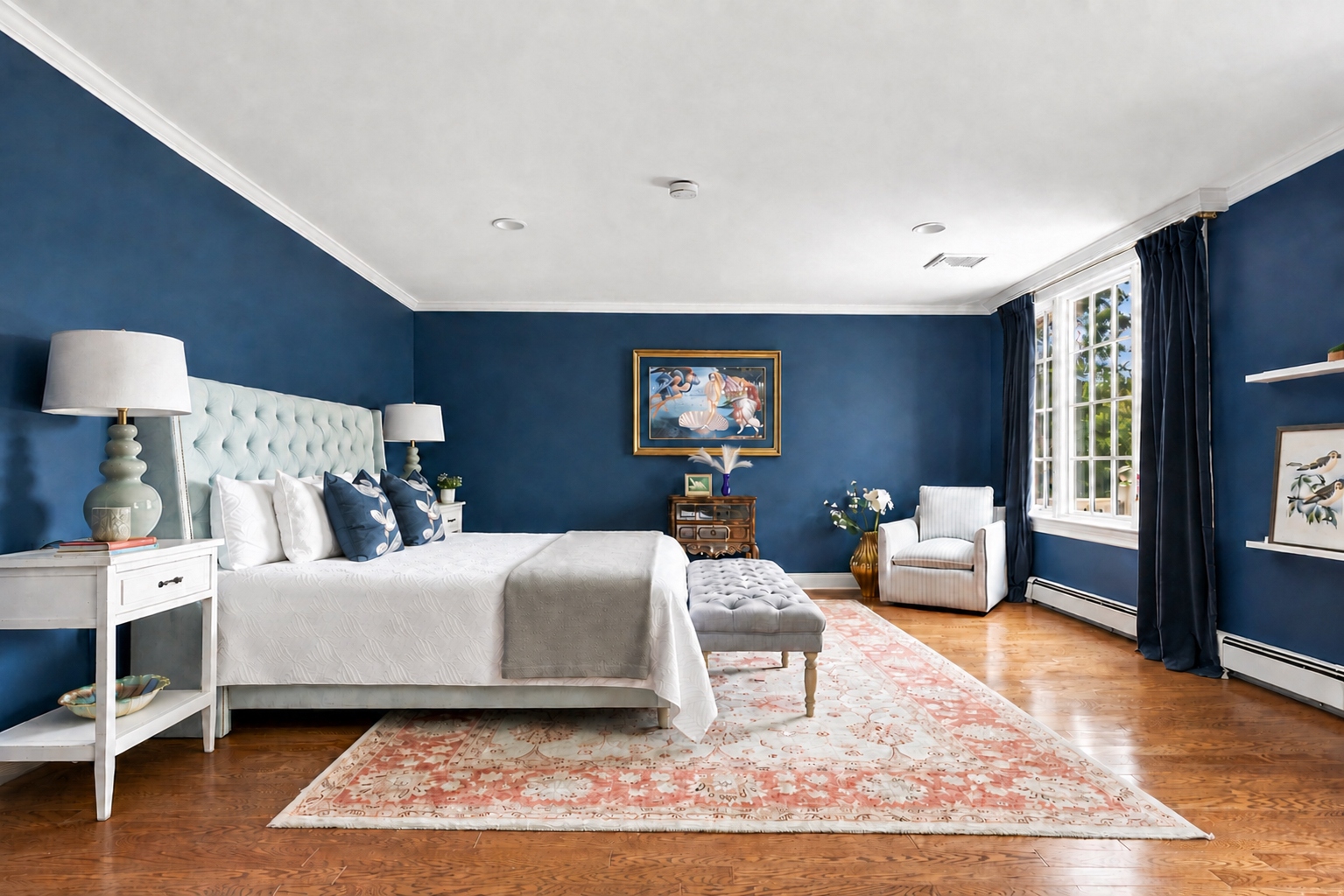 primary bedroom at 285 Hartshorn Drive with a tufted upholstered headboard and hardwood flooring