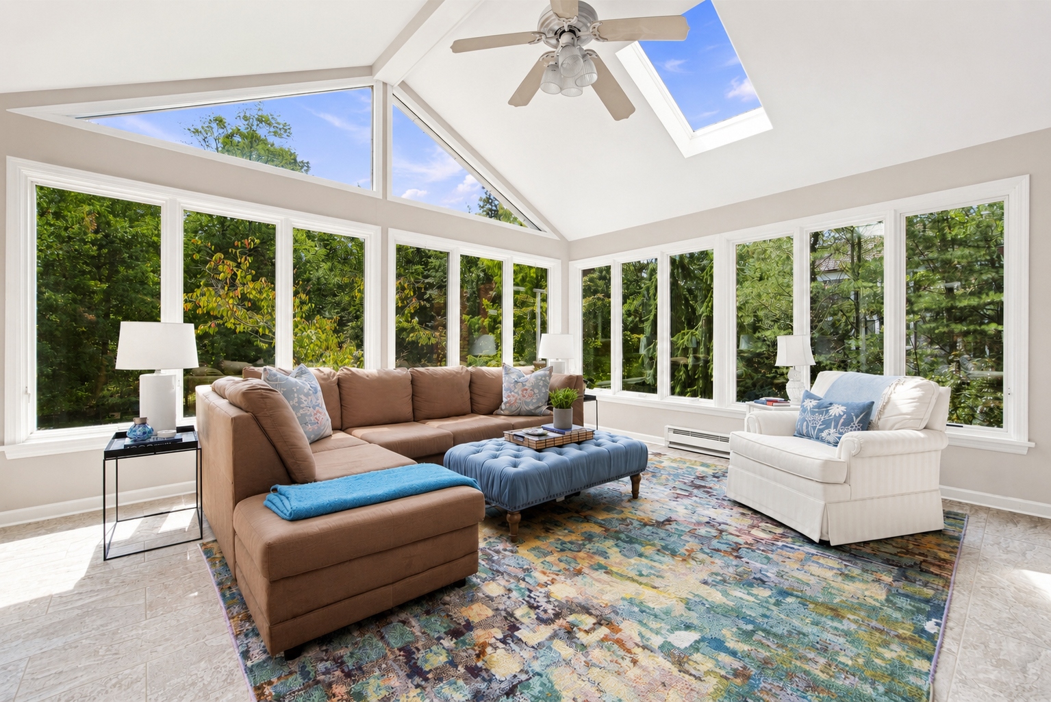 sun room at 285 Hartshorn Drive with vaulted, skylit ceiling and walls of windows