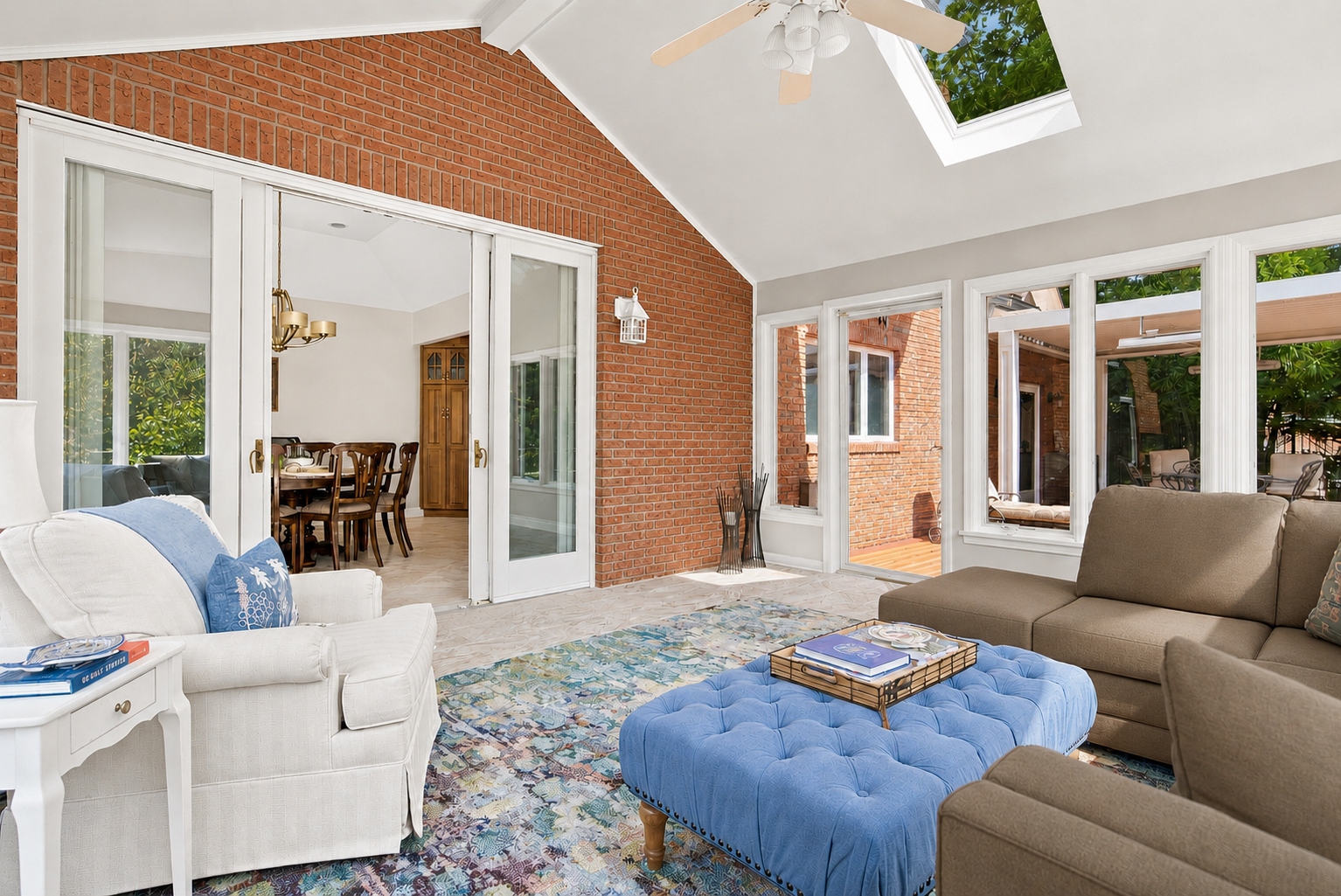 Sun room with vaulted, skylit ceiling and walls of windows at 285 Hartshorn Drive, Short Hills